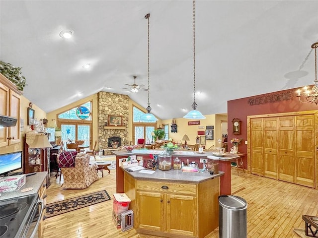 10244 124th St, Chippewa Falls, WI 54729 - kitchen featuring light wood-style floors, ceiling fan with notable chandelier, stainless steel range with electric cooktop, lofted ceiling, and open floor plan