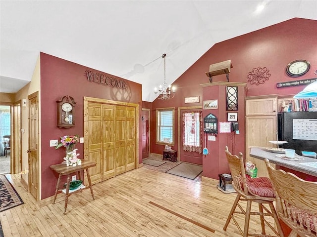 10244 124th St, Chippewa Falls, WI 54729 - foyer featuring high vaulted ceiling, hardwood / wood-style flooring, baseboards, and a chandelier