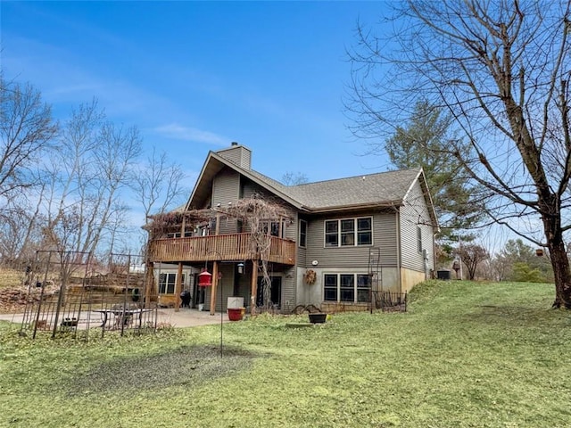 10244 124th St, Chippewa Falls, WI 54729 - rear view of house with a chimney, a patio area, a wooden deck, and a lawn
