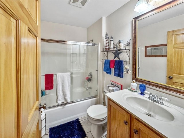 10244 124th St, Chippewa Falls, WI 54729 - bathroom with vanity, tile patterned flooring, toilet, visible vents, and bath / shower combo with glass door