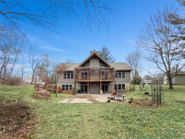 10244 124th St, Chippewa Falls, WI 54729 - back of property with a yard, a patio, a fire pit, a chimney, and a deck