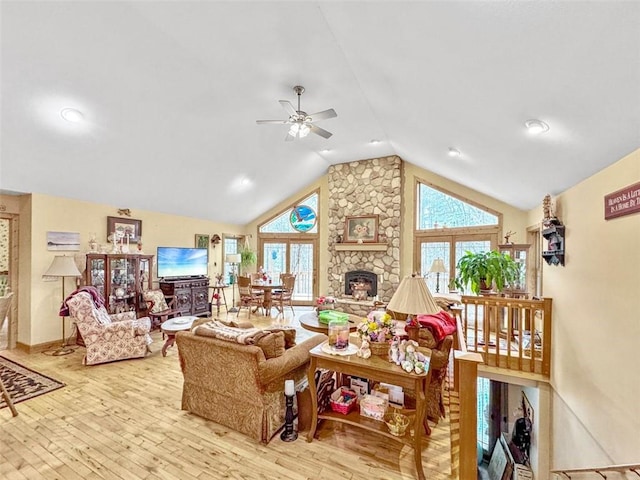 10244 124th St, Chippewa Falls, WI 54729 - living area with a stone fireplace, wood-type flooring, a ceiling fan, and vaulted ceiling