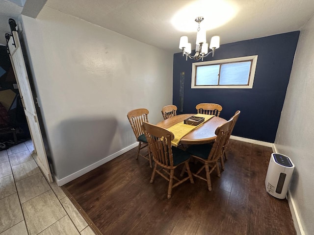 4153 N 60th St, Milwaukee, WI 53216 - dining area with baseboards, a chandelier, and wood finished floors