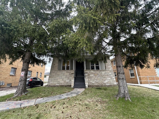 4153 N 60th St, Milwaukee, WI 53216 - view of property hidden behind natural elements featuring a front yard, stone siding, and fence