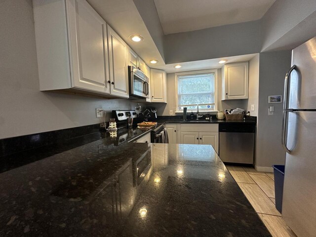 4153 N 60th St, Milwaukee, WI 53216 - kitchen with recessed lighting, white cabinetry, dark stone counters, and stainless steel appliances