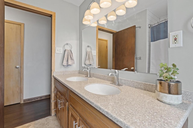 full bathroom with double vanity, a sink, and a shower with shower curtain