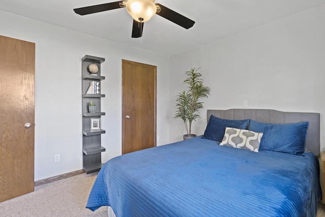carpeted bedroom with baseboards and ceiling fan
