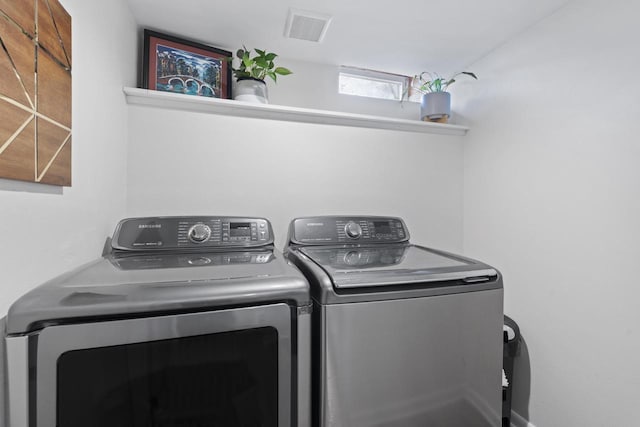 laundry room with independent washer and dryer, laundry area, and visible vents