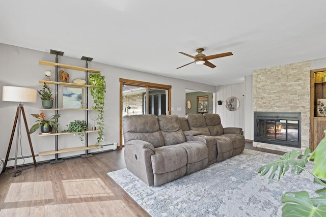 living room with ceiling fan, wood finished floors, and a fireplace