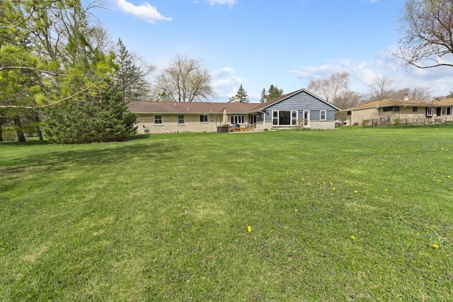 rear view of house featuring a lawn