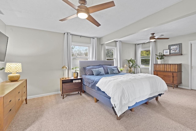 bedroom featuring baseboards, a ceiling fan, and light carpet