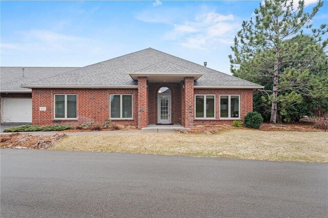 177 W Canyon Dr, Hudson, WI 54016 - single story home with brick siding, a front yard, an attached garage, and roof with shingles