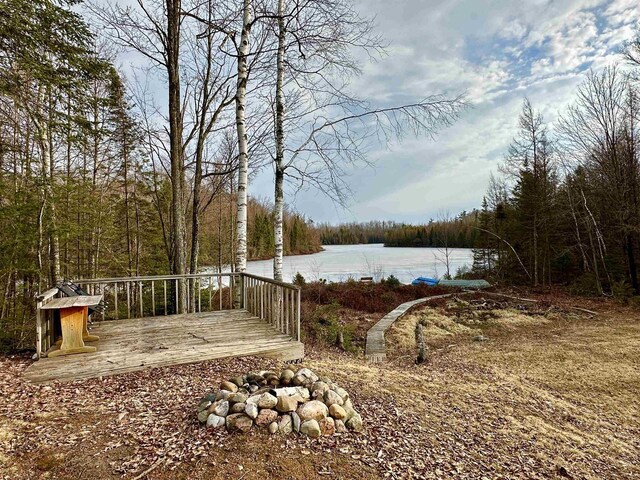 N7824 Typner Lake Rd, Deerbrook, WI 54424 - view of yard featuring a wooded view and a deck with water view