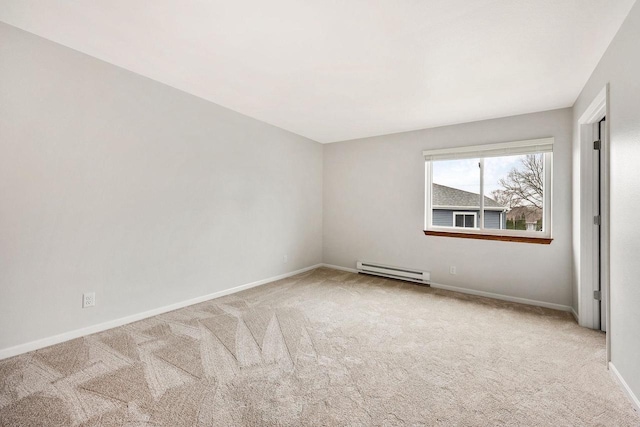 carpeted spare room with baseboards and a baseboard heating unit