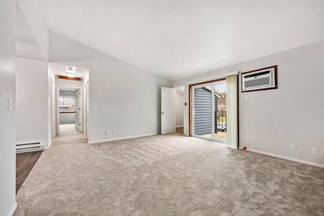 empty room featuring a wall mounted AC, a baseboard heating unit, baseboards, and carpet flooring