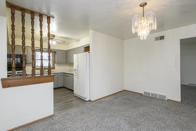 unfurnished living room with visible vents, baseboards, and carpet flooring