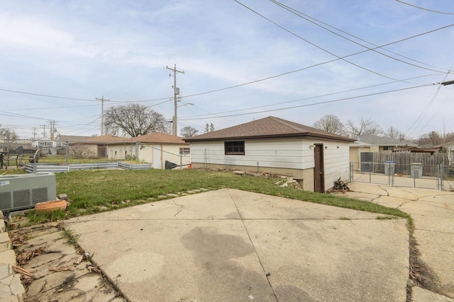 rear view of property with central AC unit, fence, a patio, and a lawn