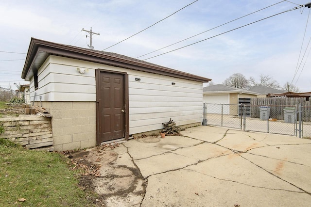 view of outbuilding with an outbuilding, fence, and a gate
