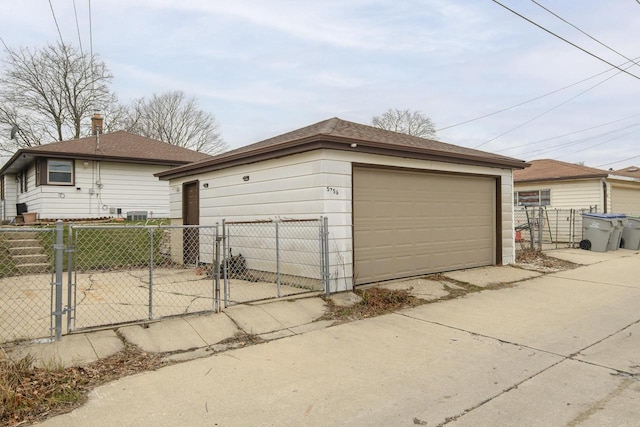 detached garage with fence and a gate