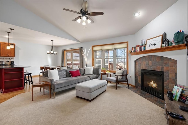 3943 Mill Run Rd, Eau Claire, WI 54703 - living room featuring vaulted ceiling, a tile fireplace, ceiling fan, light wood-style floors, and a chandelier