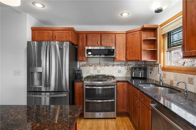 3943 Mill Run Rd, Eau Claire, WI 54703 - kitchen featuring appliances with stainless steel finishes, brown cabinets, open shelves, light wood-style floors, and recessed lighting