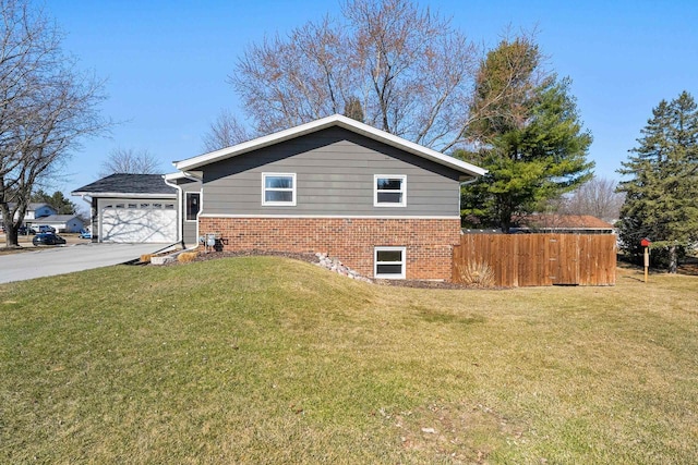 view of side of property with a yard, fence, brick siding, and concrete driveway