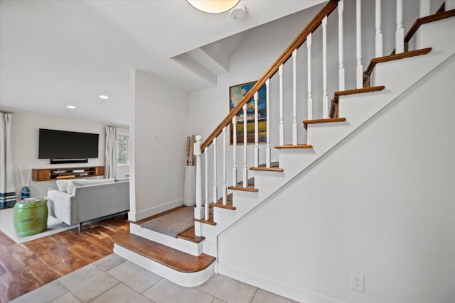 stairway featuring tile patterned floors, baseboards, and recessed lighting