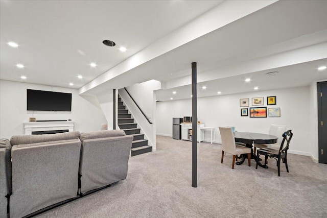living room featuring baseboards, stairway, recessed lighting, and light colored carpet