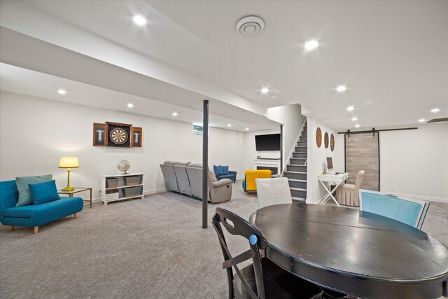 carpeted dining room with a barn door, baseboards, stairs, and recessed lighting