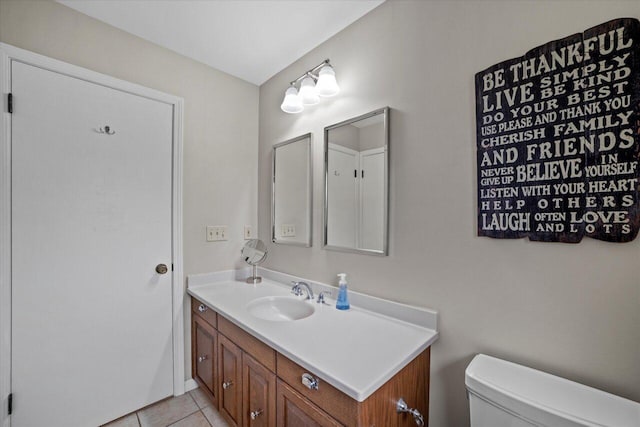 bathroom featuring tile patterned floors, vanity, and toilet