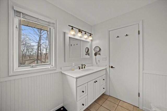 bathroom with wainscoting, vanity, and tile patterned flooring