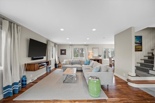 living room featuring recessed lighting, wood finished floors, visible vents, baseboards, and stairs