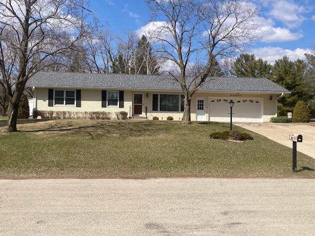ranch-style home with an attached garage, a front lawn, and concrete driveway