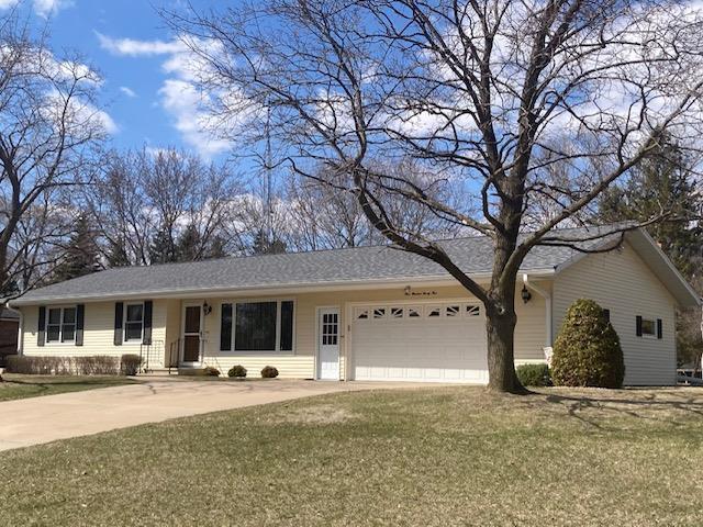 ranch-style home with an attached garage, driveway, and a front yard