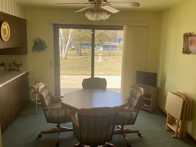 dining room featuring carpet flooring and a ceiling fan