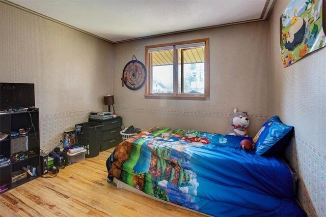 607 Cross Ave, Amery, WI 54001 - bedroom with wood finished floors and wallpapered walls