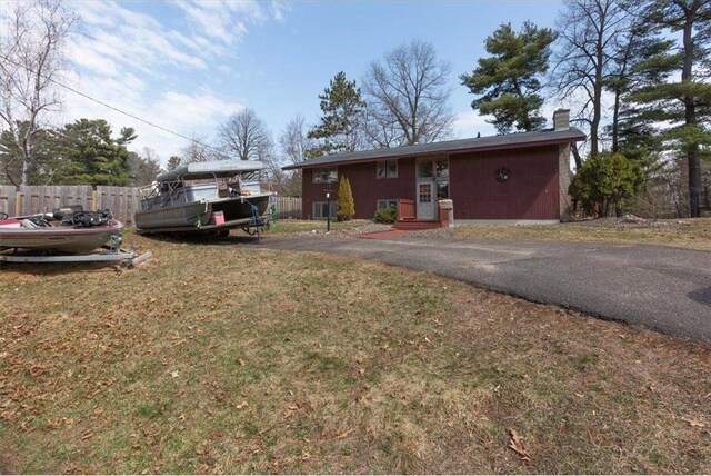 607 Cross Ave, Amery, WI 54001 - exterior space with a yard, fence, and a chimney