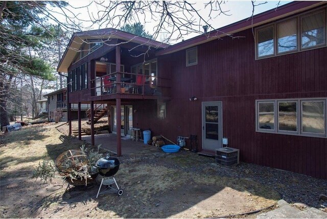 607 Cross Ave, Amery, WI 54001 - back of house featuring stairway, cooling unit, and a wooden deck