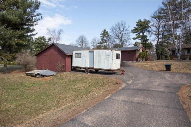 607 Cross Ave, Amery, WI 54001 - view of shed featuring aphalt driveway