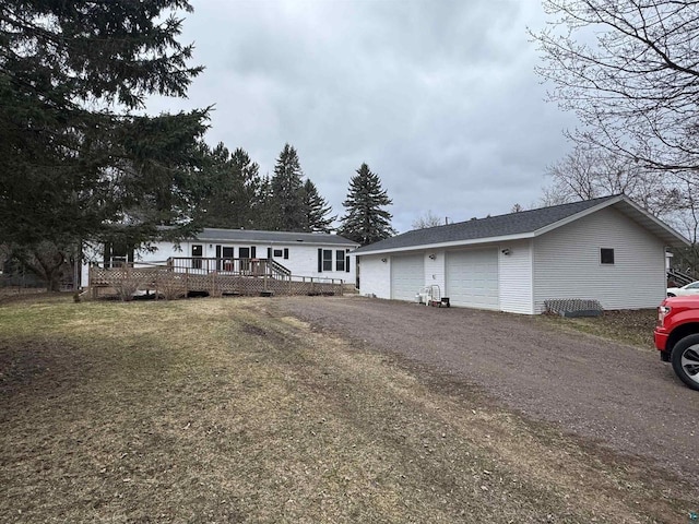 68485 N George St, Iron River, WI 54847 - view of front of home featuring an outbuilding, a wooden deck, a detached garage, and a front yard