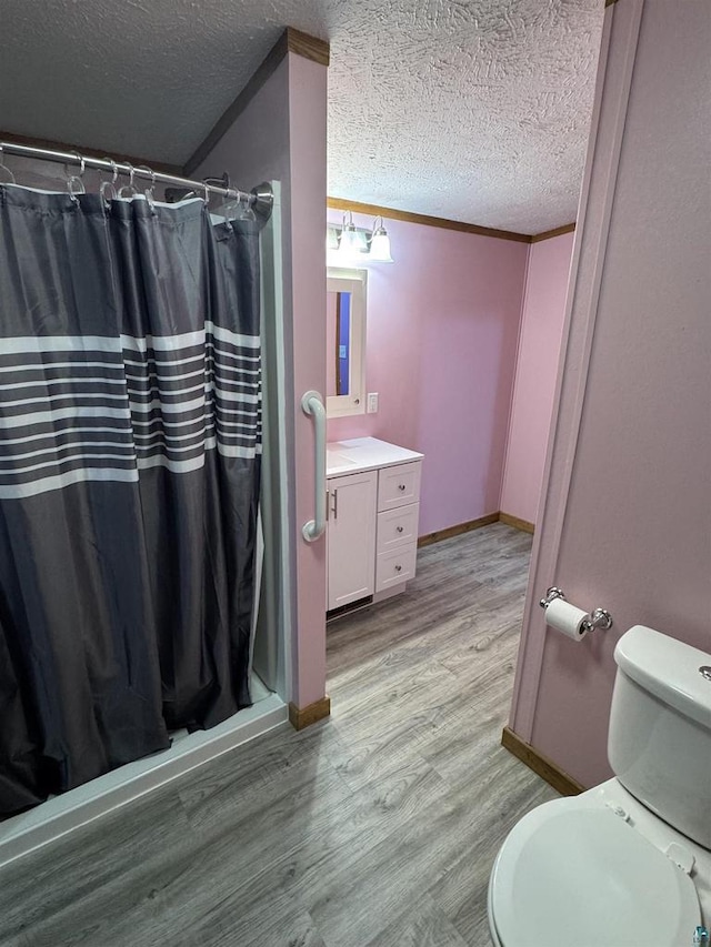 68485 N George St, Iron River, WI 54847 - full bath featuring wood finished floors, baseboards, a textured ceiling, vanity, and a shower with shower curtain