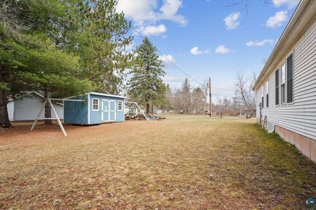 68485 N George St, Iron River, WI 54847 - view of grassy yard with a storage shed and an outdoor structure