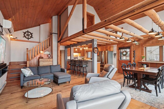 W9160 Ripley Rd, Cambridge, WI 53523 - living area with wooden ceiling, an AC wall unit, light wood-type flooring, stairs, and high vaulted ceiling