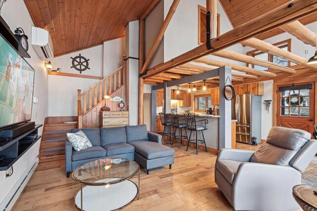 W9160 Ripley Rd, Cambridge, WI 53523 - living area featuring light wood finished floors, high vaulted ceiling, stairs, and a wall unit AC