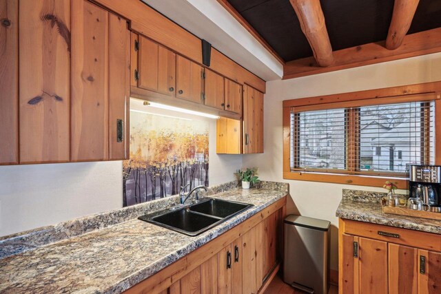 W9160 Ripley Rd, Cambridge, WI 53523 - kitchen featuring light countertops, brown cabinets, a sink, and beam ceiling