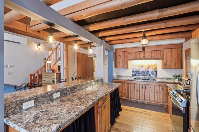 W9160 Ripley Rd, Cambridge, WI 53523 - kitchen featuring a wall mounted AC, light wood-type flooring, stainless steel electric range oven, brown cabinetry, and beam ceiling