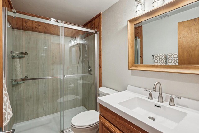 W9160 Ripley Rd, Cambridge, WI 53523 - bathroom featuring vanity, a stall shower, visible vents, and toilet