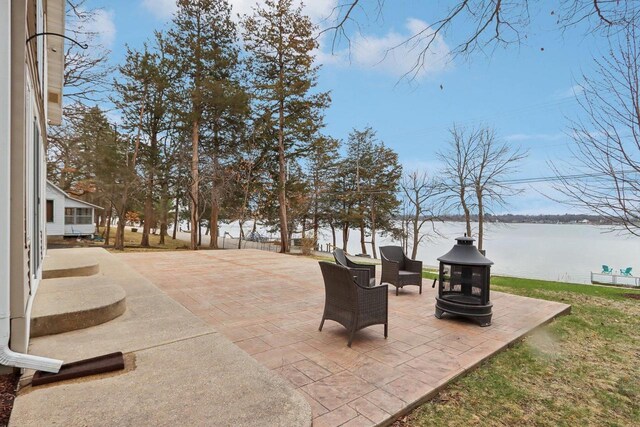 W9160 Ripley Rd, Cambridge, WI 53523 - view of patio / terrace featuring a water view and an outdoor fire pit