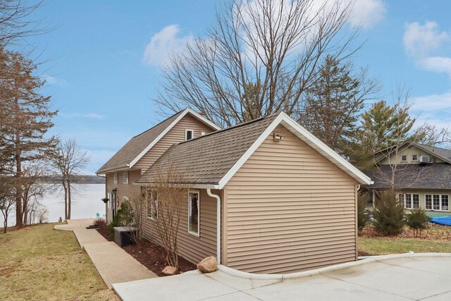W9160 Ripley Rd, Cambridge, WI 53523 - view of side of property featuring a yard, a shingled roof, and central air condition unit