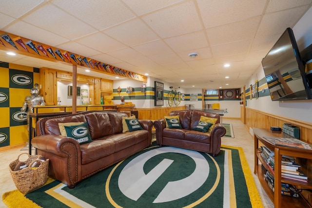 1501 Walls St, Green Bay, WI 54304 - living area featuring a drop ceiling, wood walls, a wainscoted wall, and bar area